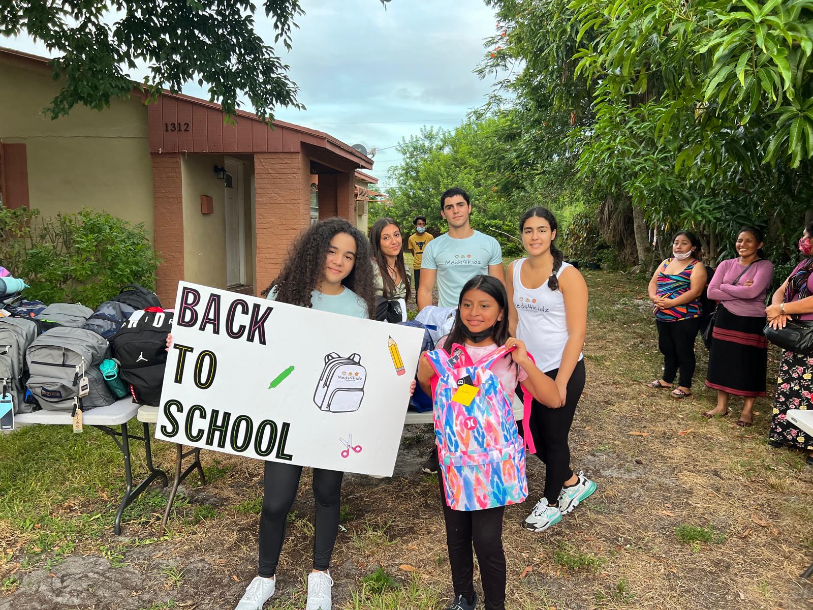 Annual Back-to-School Supply Drive - Ariela Tejada and Student with Backpack