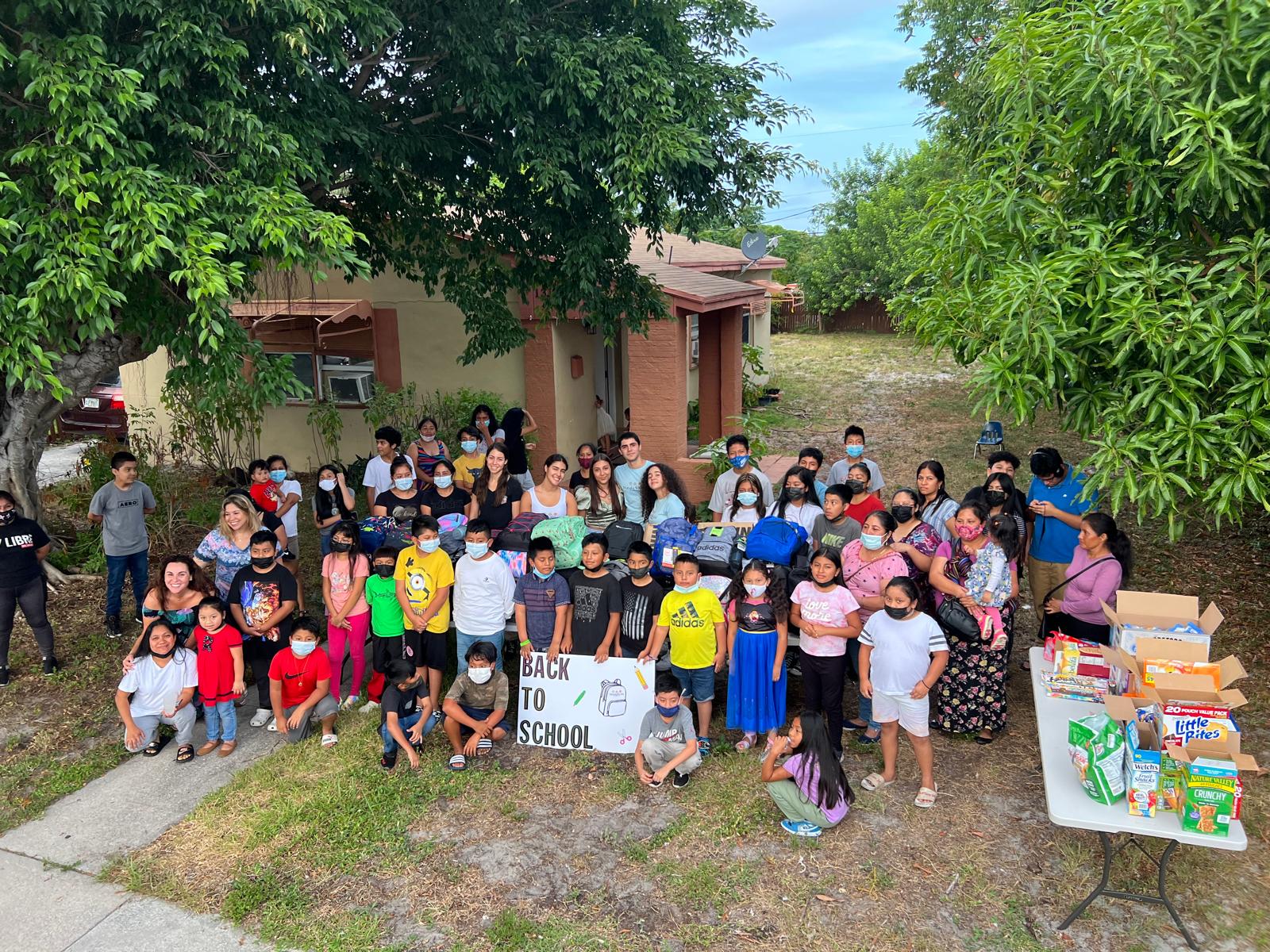 Large community gathering of families and volunteers