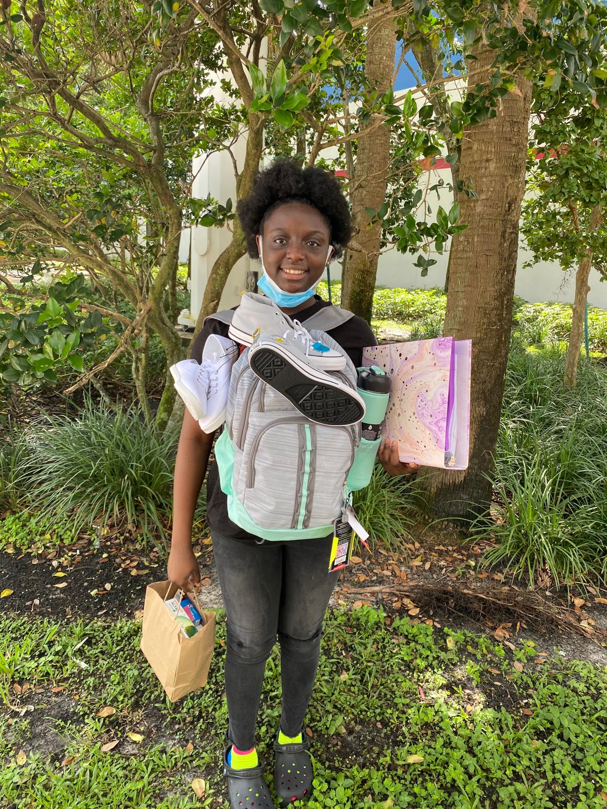 Student with Converse sneakers and supplies