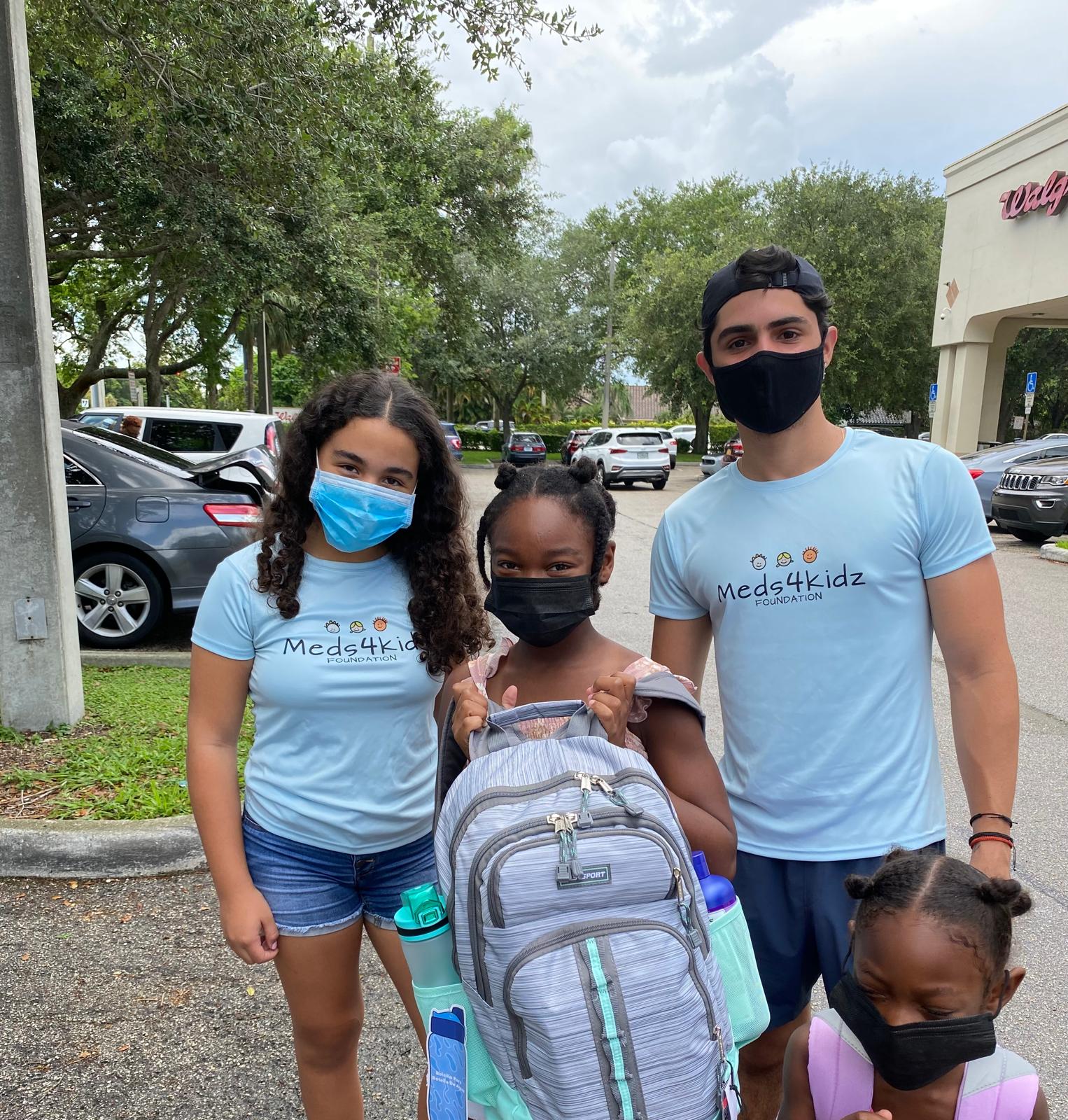 Meds4Kidz volunteer team with student