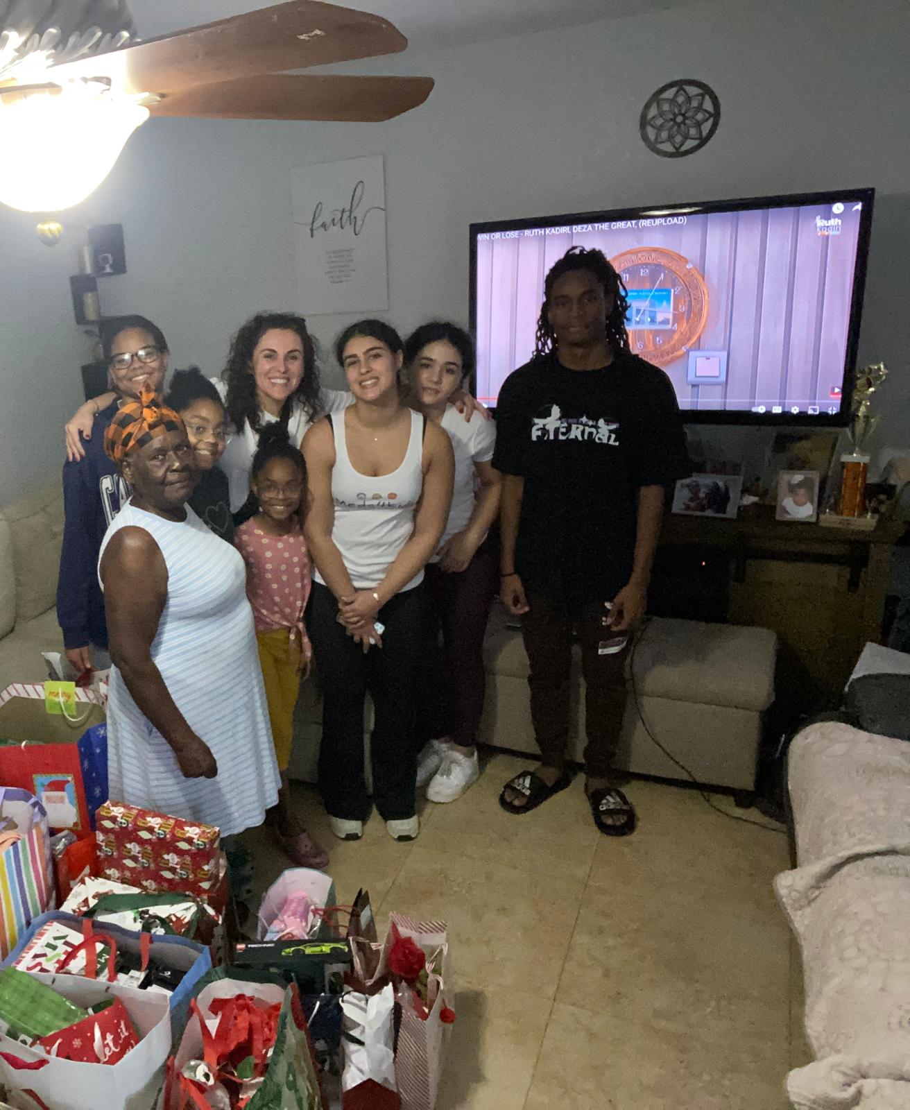Meds4Kidz team in living room surrounded by gifts