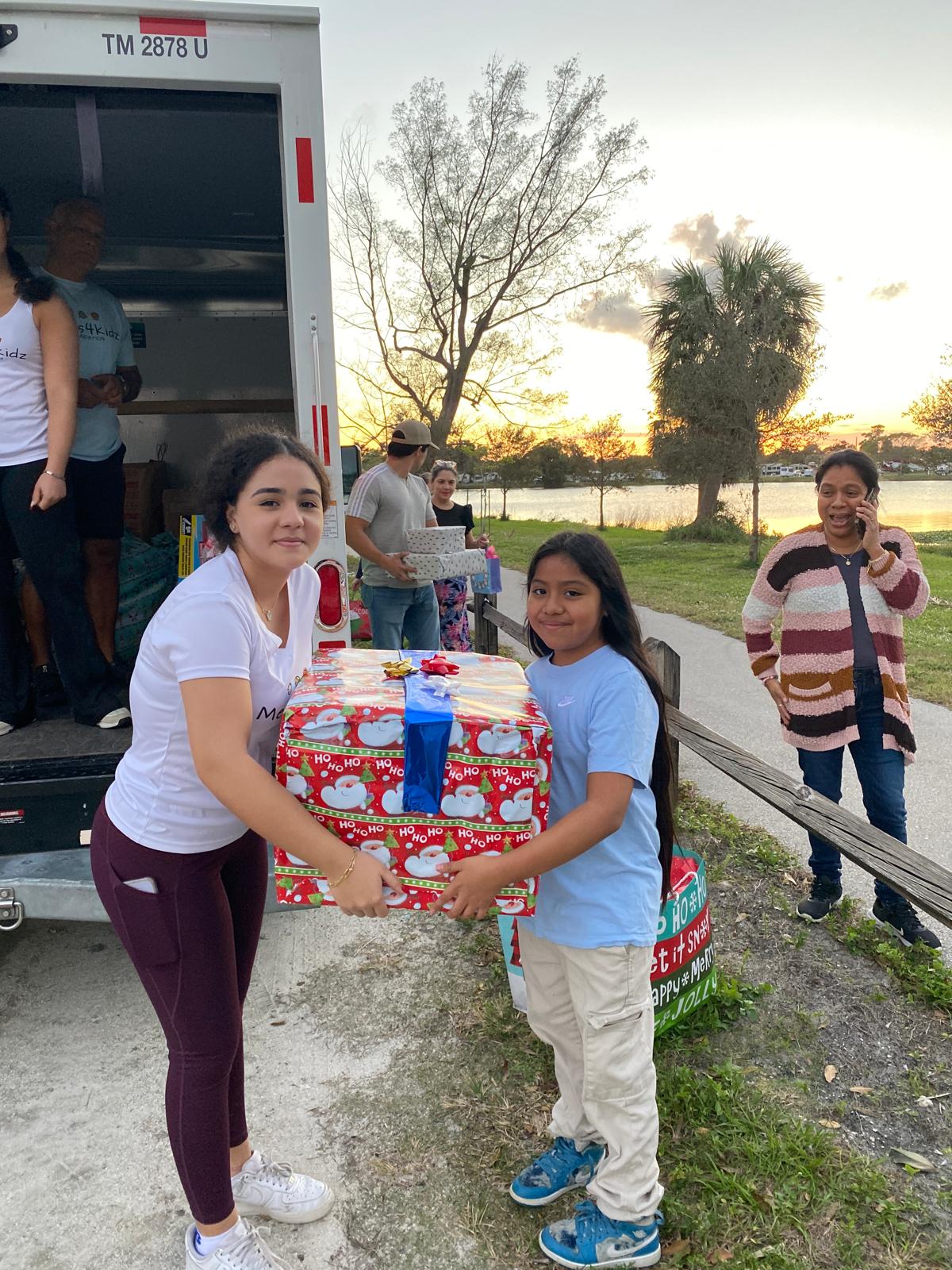 Ariela delivering gift to girl by lake