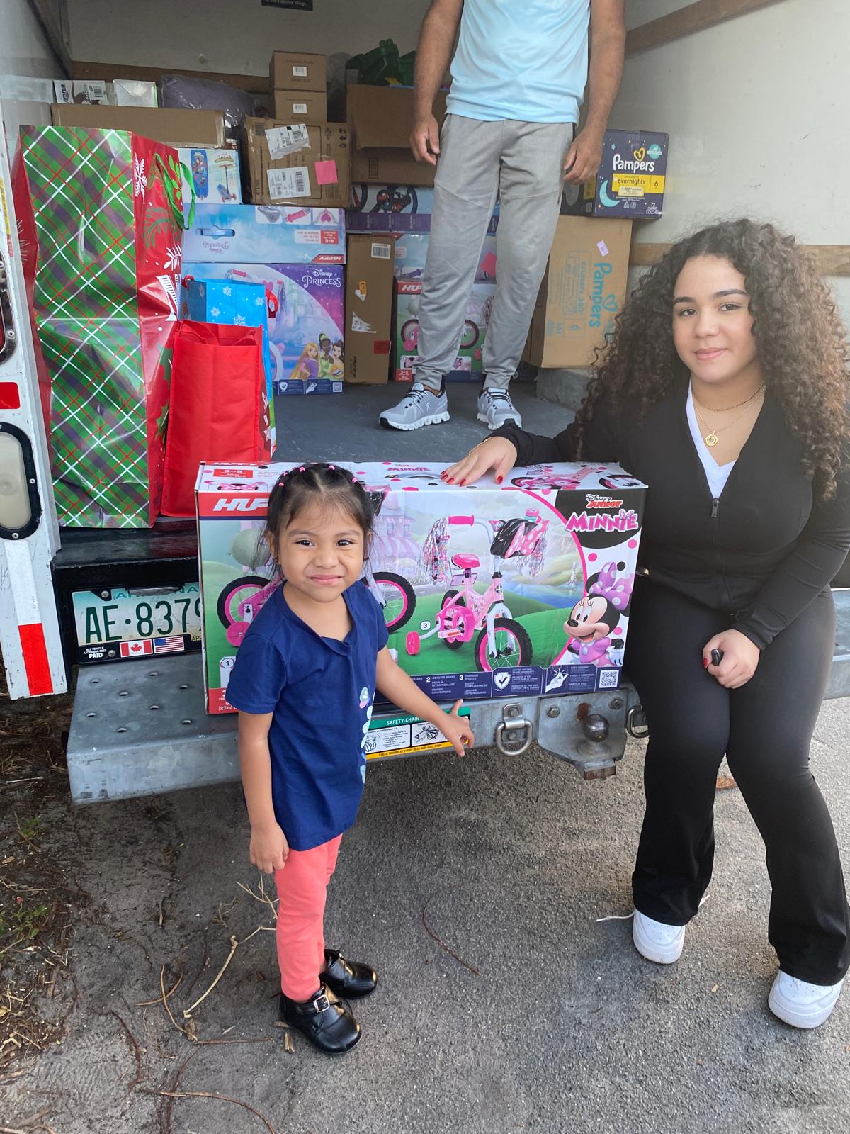 Ariela Tejada delivering Minnie Mouse bike
