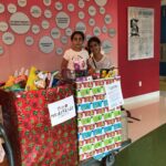 Ariela Tejada with Meds4Kidz Holiday Toy Drive boxes at Joe DiMaggio Children's Hospital
